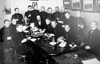 Photograph of the members of the Senior Class of the Alexander Lyceum having tea with two of the masters