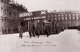 Photograph of Russian soldiers marching past the Winter Palace in Petrograd