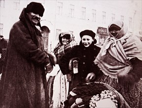 Photograph of a hawker of gloves, mittens and other woollens in Moscow