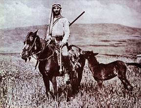 Jewish 'Shomer' settler guard in afield protecting a small settlement