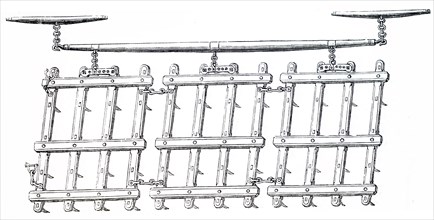 A common type of rhomboidal harrow which would be used to implement the breaking up and smoothing out the surface of the soil