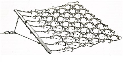 A chain harrow which would be used to implement the breaking up and smoothing out the surface of the soil