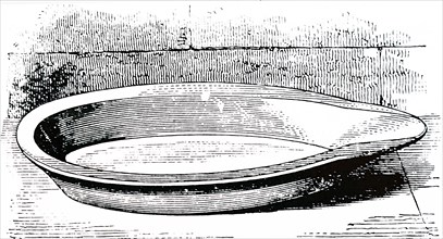 A stoneware milk-dish in which cream was allowed to rise