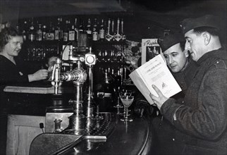 Photograph of French soldiers from the Vichy government on-leave in Paris visiting a bar