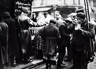 Photograph of a French soup kitchen distributes food to hungry people, in Paris, during the German occupation 1941