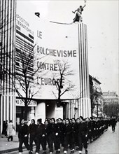Photograph taken of a Pro-German march, past the Paris exhibition 'Bolshevlsme contra l'europe', during the German occupation of France, in World War Two