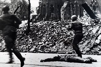 Photograph of Soviet Red Army soldiers during a street battle during the Siege of Berlin which helped bring on the German surrender in World War Two 1945