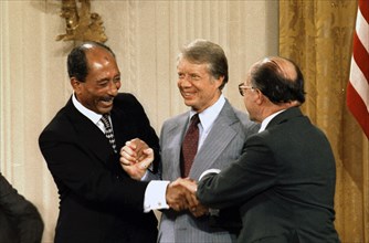Egyptian President Anwar Sadat, United states President Jimmy Carter and Israeli Prime Minister Meacham Begin, celebrate after signing the Camp David Peace Accords 1978
