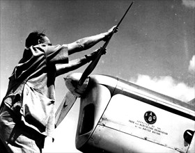 Photograph of a pilot of the Food and Agricultural Organisation checking his plane