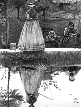 A woman looking at her reflection in the water, whilst she fishes