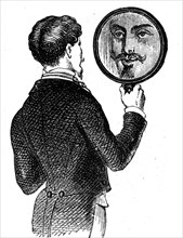 A young man looking at himself in a mirror