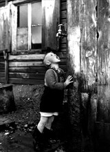 Photograph of a refugee boy drinking from a tap which is the sole source of water for the entire unofficial refugee camp known as Bahnhofstrasse