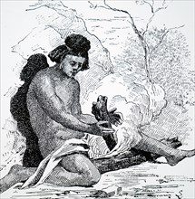 A North American Indian using a bow drill, a prehistoric form of drilling tool, which was used to produce fire