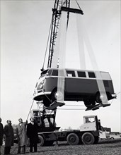 Photograph taken of a Volkswagen van being lifted into the air by a sling made from the 'Mylar' T polyester film