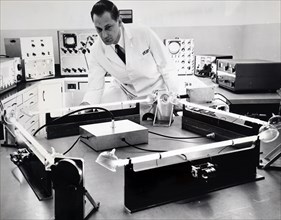 Photograph of a scientist testing a 'closed-circuit' laser that appears to be superior to a gyroscope for guiding spacecraft, rockets, airplanes and ships