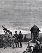 An astronomer and his female assistant observing Mercury, Venus and Jupiter from a roof top observatory in Paris