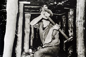 Photograph of a miner working in a British mine