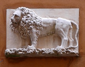 The Lion symbol of Venice, depicted on a wall relief, in the city