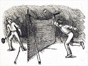 A friendly game of badminton between two young boys