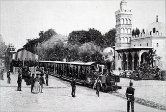 A Decauville locomotive carrying passengers in the Esplanade des Invalides, Paris