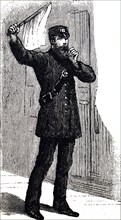 A signalman waving his flag and blowing a whistle to get attention of an oncoming train