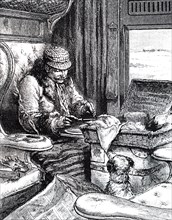 A man in a first class carriage preparing to eat his lunch