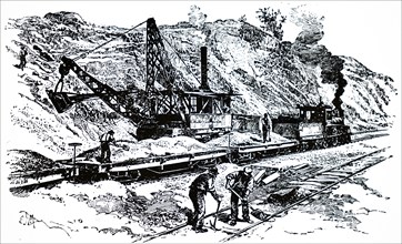 A steam excavator working on a railway embankment