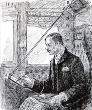 A passenger in a first-class carriage using a suspended writing slope