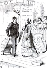 A railway porter bringing a passenger her luggage