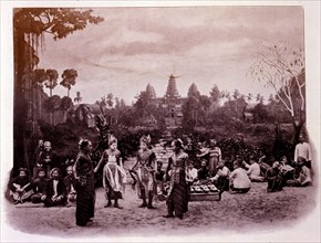 Photograph showing Javanese dancers outside the famous pagoda of Angkor