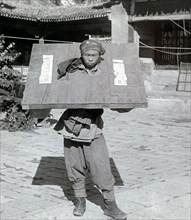 Boxer rebel wearing a prisoner yoke during the The Boxer Rebellion
