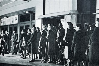 People queuing outside a cinema in the Old Kent Road, London, during the power station workers strike