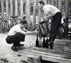 French men filling bottles of fuel to use against the German invasion of France