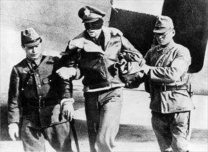 U.S. Army Air Force Lt. Robert L. Hite, blindfolded by his captors, is led from a Japanese transport plane