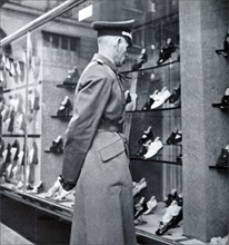A German officer looks at the empty shops in Paris during World War II