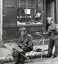 German soldiers painting in the deserted streets of Paris during World War II