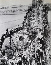Korean War: Thousands of North Korean crossing a partly destroyed bridge on the Taedong River, fleeing Communist troops