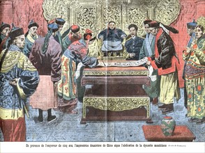 After the proclamation of the Republic of China, the dowager empress, in the presence of the 5-year-old emperor, sign the abdication of the Manchu Dynasty. /