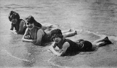 Charming bathers on the beach, postcard