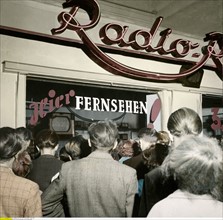 People gathered in front of a shop window, 1951