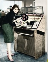Young woman next to a jukebox