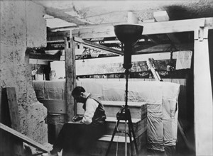 Howard Carter examines the tomb of Tutankhamun, 1923