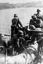 Invasion of the Netherlands: German Soldiers crossing the Meuse. in rubber dinghys