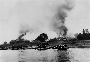 Invasion of the Netherlands: German Soldiers crossing the Meuse. in rubber dinghys