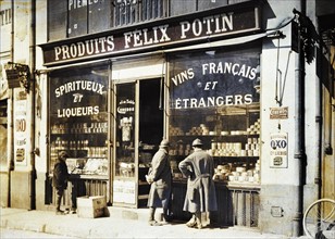 Deux soldats français et un jeune garçon, devant la vitrine d'un magasin Félix Potin à Reims