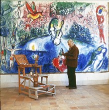 Painter Marc Chagall and his painting >Commedia dell`Arte< Photograph. 1959.