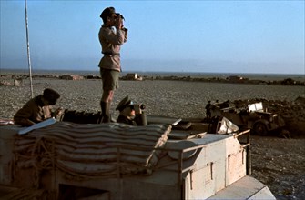 Field Marshal Erwin Rommel watching battlefield 1941 Tunisia in Captured British armoured truck MAX. MAMMUT