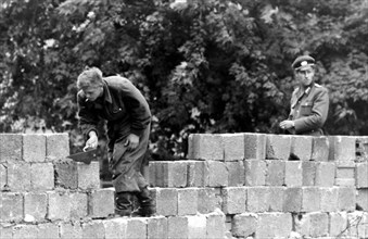 Germany Berlin - East German policemen building up the wall