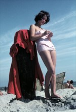 A woman in a bathing suit at the beach