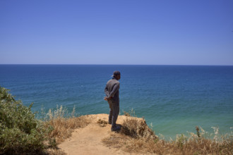 Un homme regarde la mer  en Algarve